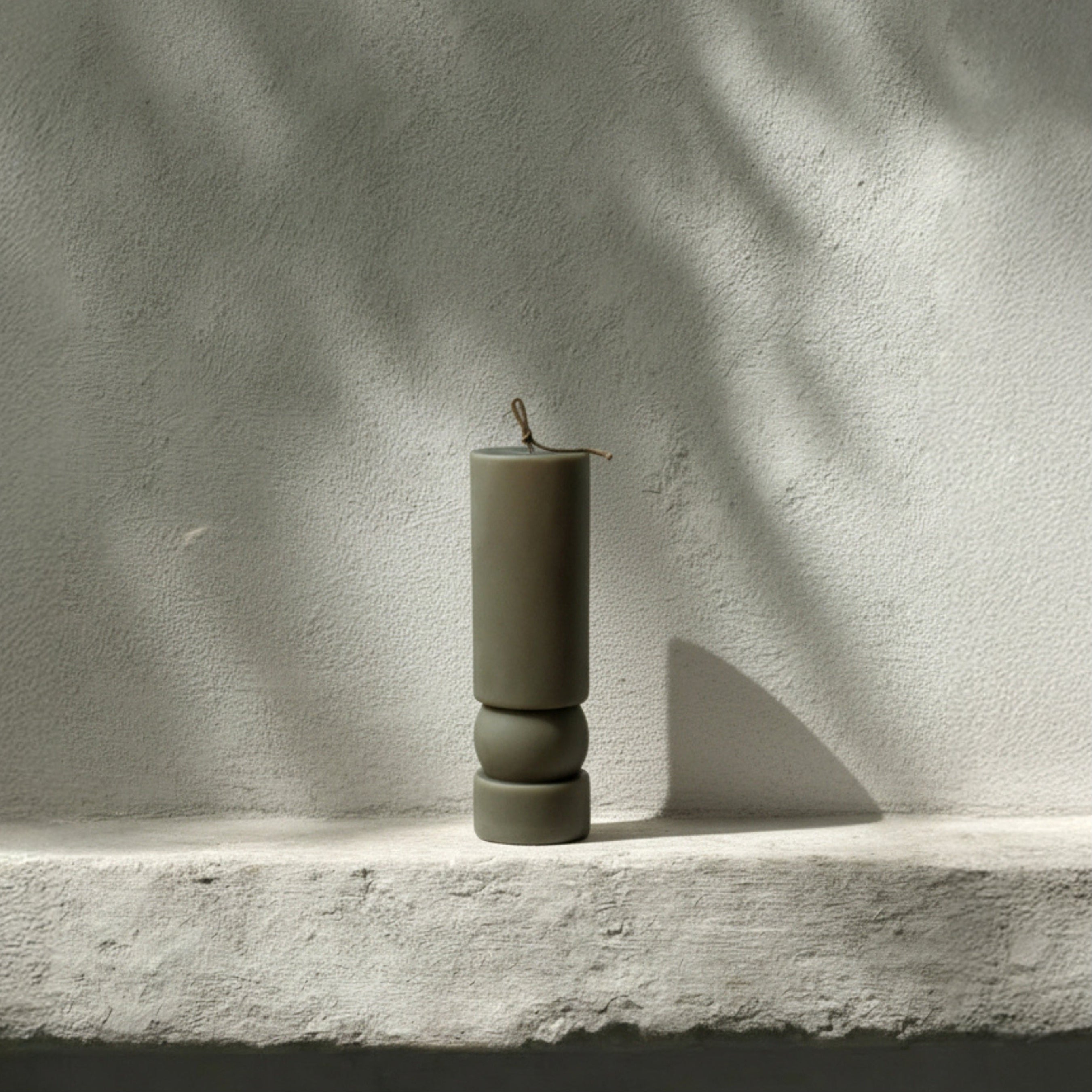 Earthy green Zen sculptural soy wax candle by LAWA, modern pillar design for contemporary home styling in the neutral setting